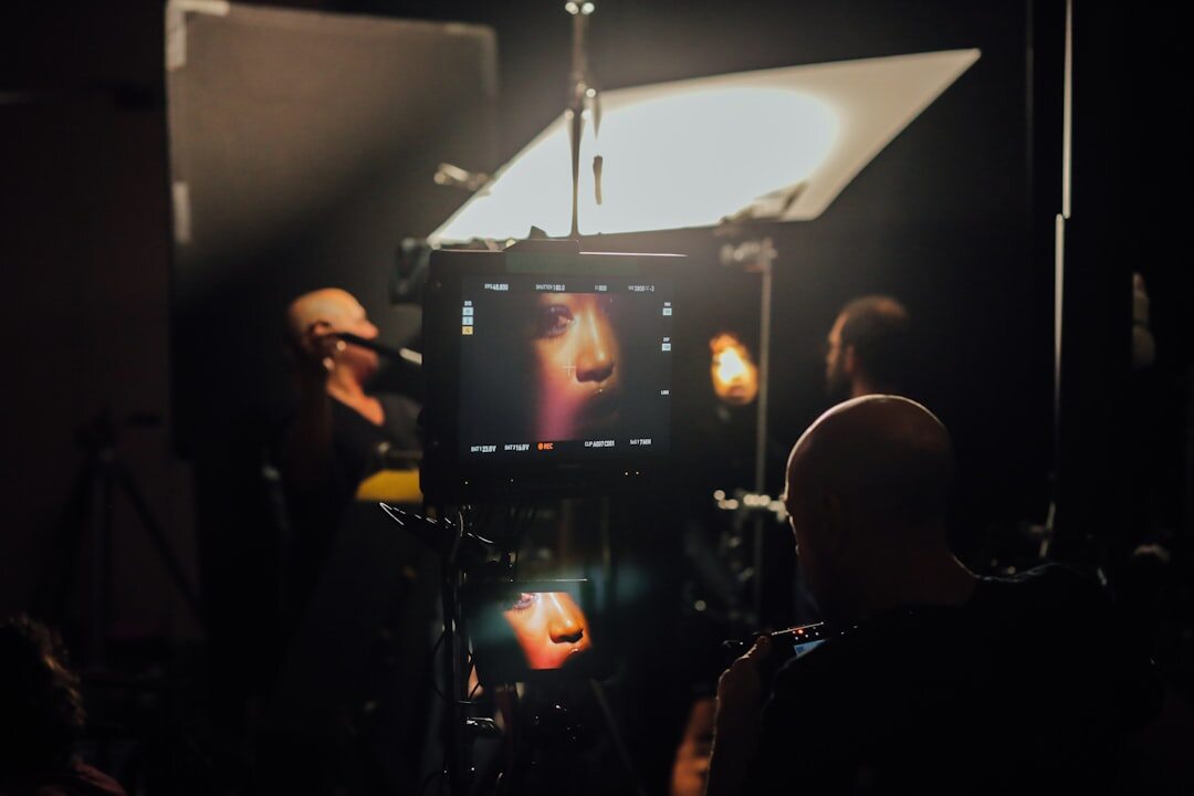 Diverse broadcast production team gathered around a monitor